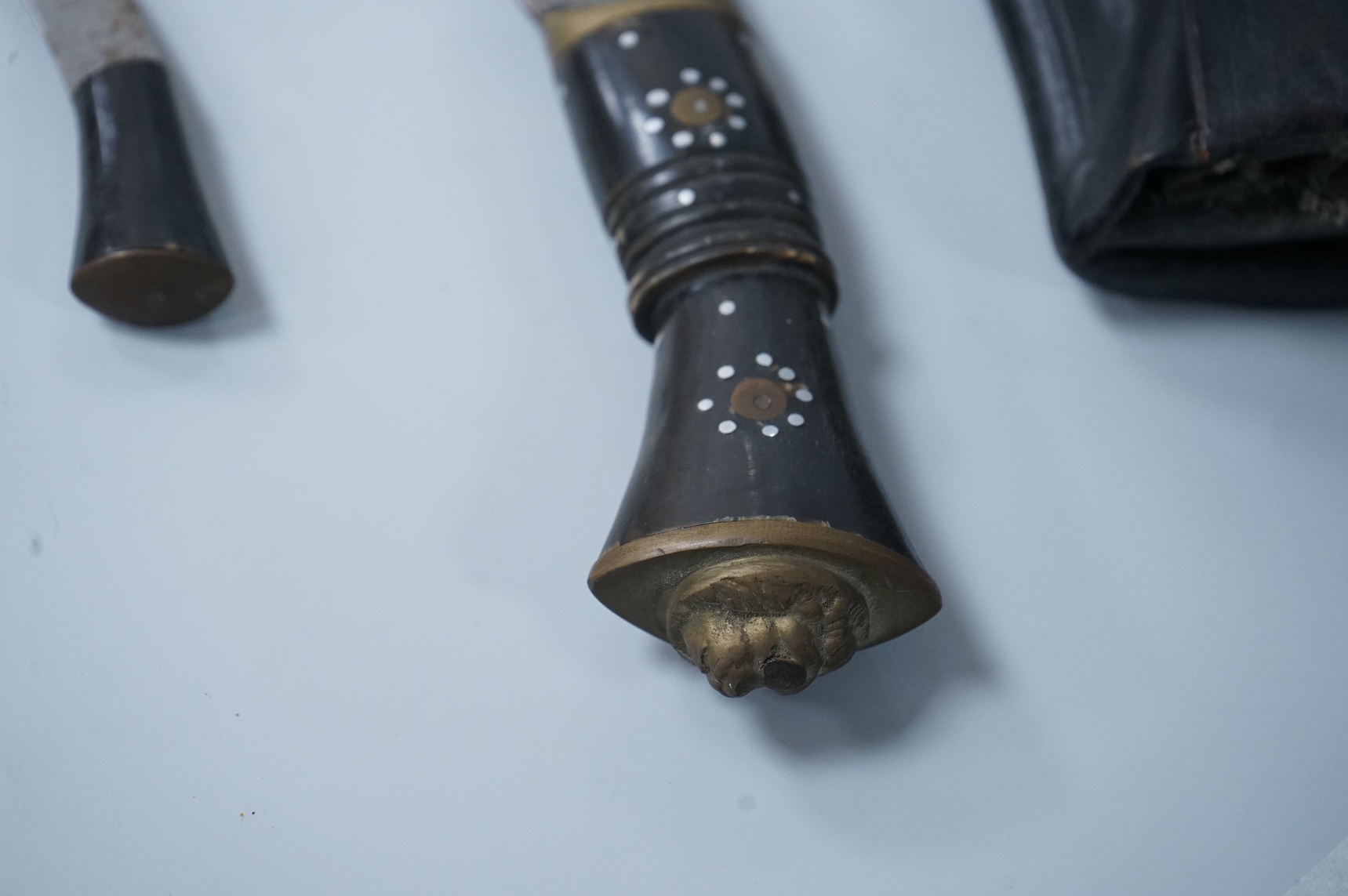 Two kukri knives in leather covered scabbards